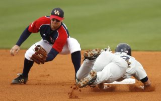 Baseball players catching the ball and sliding into first base - Tendo Sport