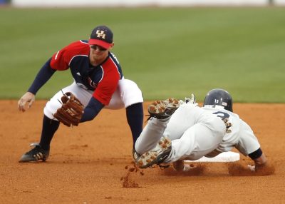Baseball players catching the ball and sliding into first base - Tendo Sport