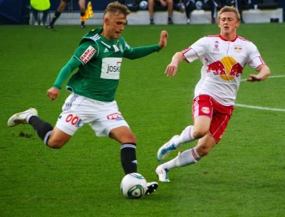 football players fighting over a ball during a match - Tendo Sport