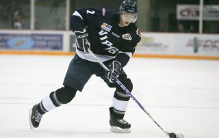 Male ice hockey player skating with a puck - Tendo Sport