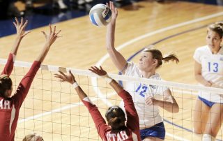 Women volleyball players fighting over a net for the point - Tendo Sport