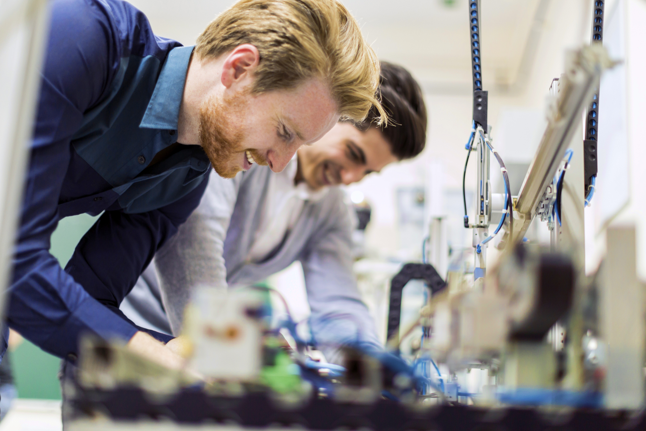 Two young engineers working on Tendo Sport electronic components and fixing broken parts