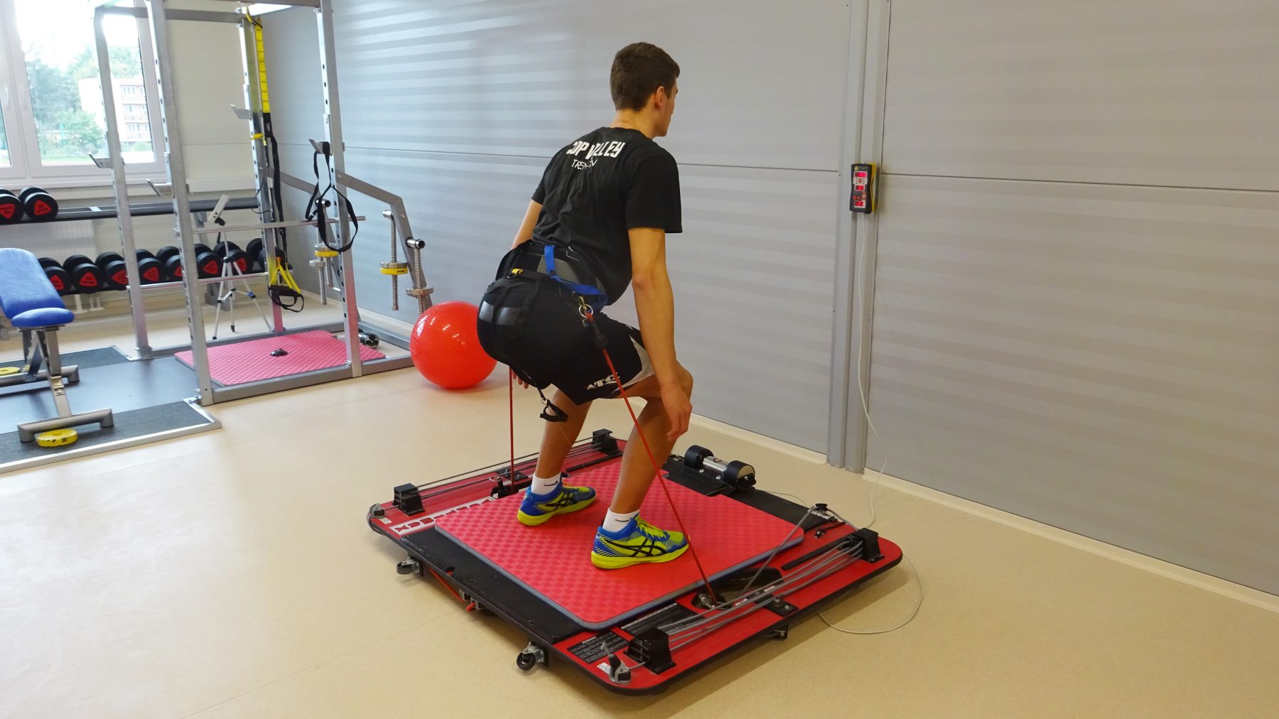 Male athlete performing jumps with Vertimax. Measuring power and velocity of legs using Tendo Unit and Tendo JumpMat